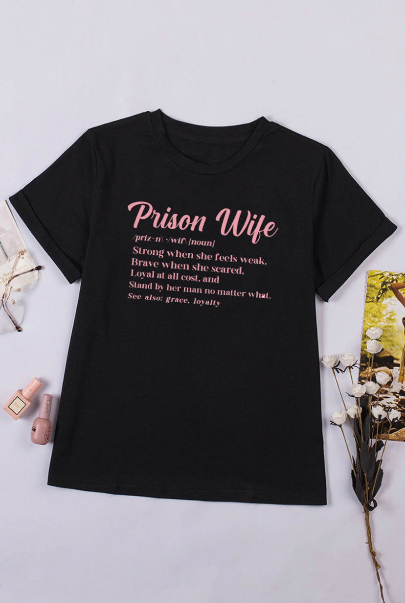 A prison wife tshirt  with a definition that reads  "Prison Wife: A woman that's strong when she feels weak, brave when she feels scared, loyal at all cost and will stand by her man no matter what. Also see, grace, loyalty." It's a powerful reminder of the strength and resilience of prison wives, and a celebration of the qualities that make them so special